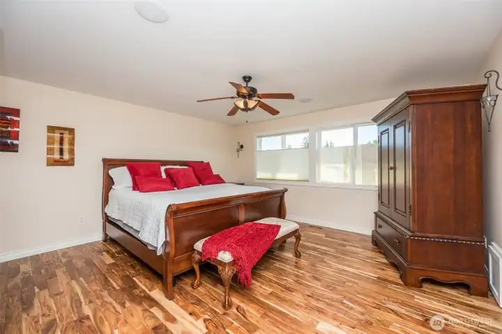 Owner's Suite with new Acacia hardwoods in bedroom and walk in closet, ceiling fan, surround sound, french doors off 5 piece bath Owner's Suite with new Acacia hardwoods in bedroom and walk in closet, ceiling fan, surround sound, french doors off 5 piece bath
