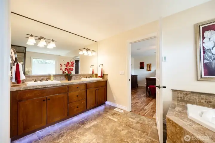 Owner's Suite 5 piece bathroom with heated travertine floors, jacuzzi soaking tub, bidet toilet, walk in closet with new Acacia hardwoods Owner's Suite 5 piece bathroom with heated travertine floors, jacuzzi soaking tub, bidet toilet, walk in closet with new Acacia hardwoods