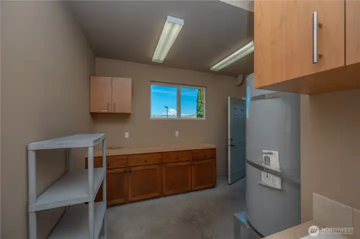 Shop with cabinetry, built in sink and cabinets, interior/exteriro door leads to covered patio Shop with cabinetry, built in sink and cabinets, interior/exteriro door leads to covered patio
