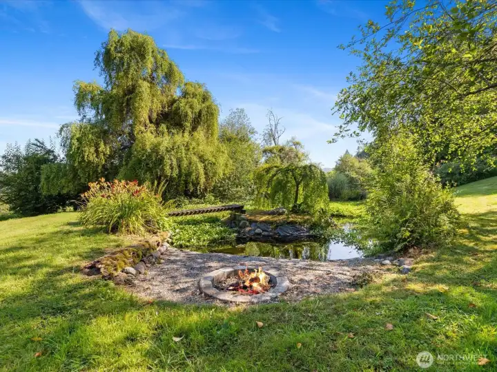 Year-round pond with fish, bridge to small island and firepit