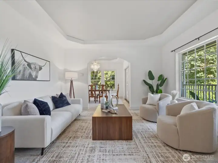 Formal living room with views and tray ceiling