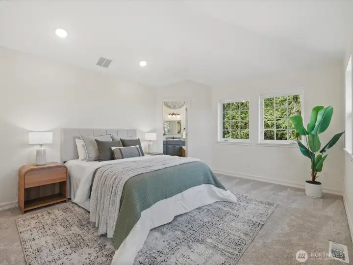 Primary bedroom with vaulted ceilings