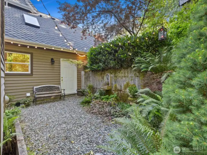 Your very own courtyard with bench and custom stone fountains. And access to garage