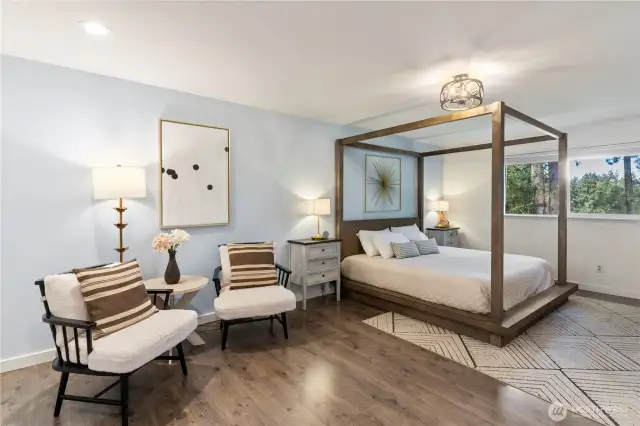 Spacious primary bedroom with seating area