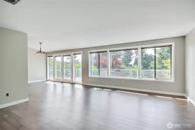 Great room on main floor. Check out the window coverage and the plexiglass-railed deck.