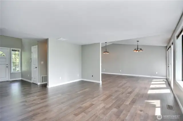 Another angle of the main floor great room. Tons of space for dining, living and looking at that lovely view. (Main entry toward the left of this photo.