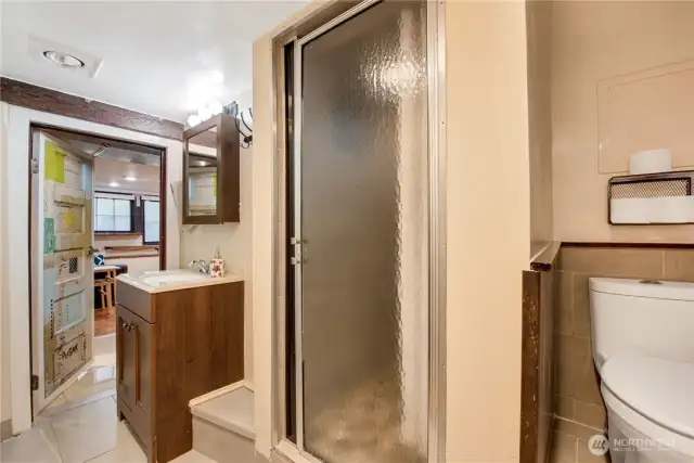 Artist unit bathroom. Shower has river rock floor and rainfall shower head.