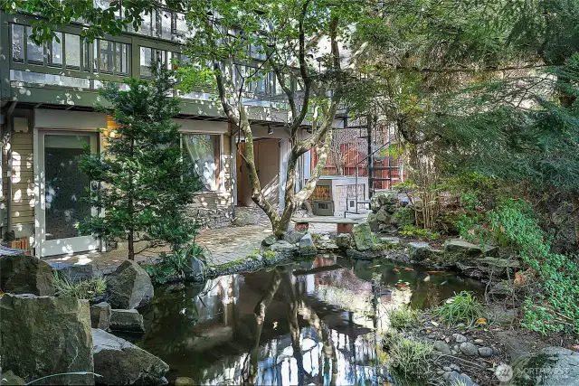 Both lower units are accessed from the backyard. Garden (1bed) unit door and bedroom window (pictured here) look directly at the pond. Sun-room and main house patio above.