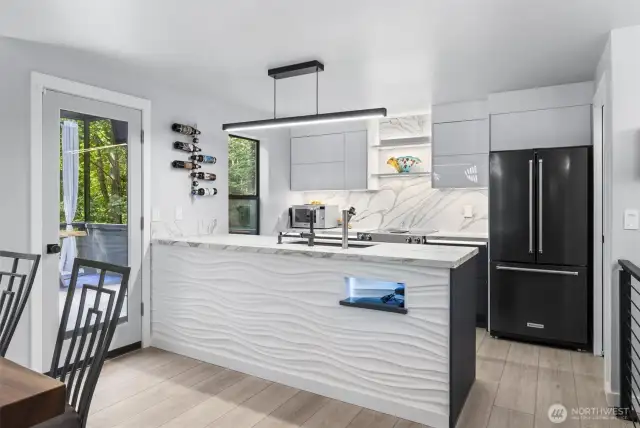 This modern kitchen boasts custom cabinets, high-end countertops, premium appliances, and a sleek backsplash—where style meets function.