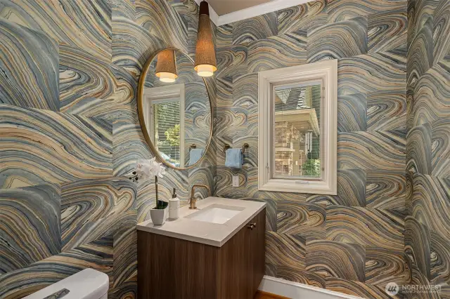 Main floor powder room with incredible wallpaper - another example of the level of design that can be found in this home.