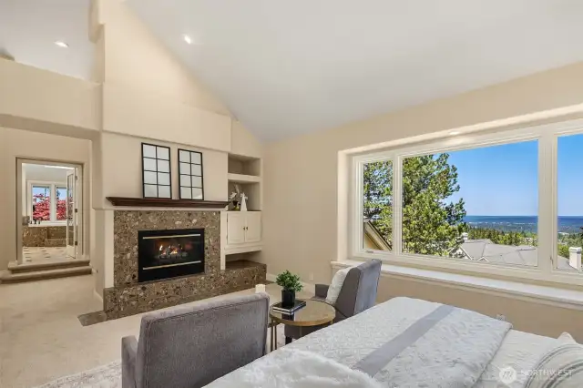 Primary suite includes a wonderful gas fireplace. The window seat perfectly balances the window and the extensive views