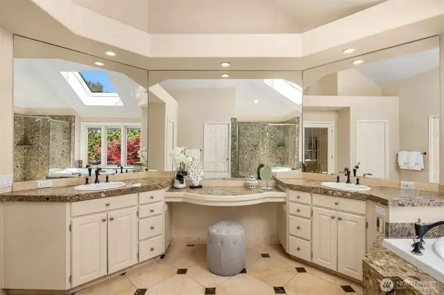 Once more the architectural detailing continues in the primary bath. Large mirrors reflect the view, dual vanities, make up station and heated floors.