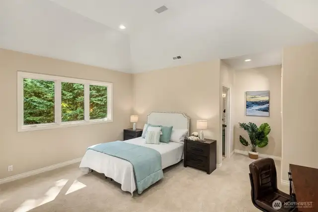 There are three generous secondary bedrooms on the upper floor, all with vaulted ceilings. This private guest suite, complete with a private full bath and built-in media cabinetry is perfect for extended guests, multi-generational living, or what a lovely nanny suite!