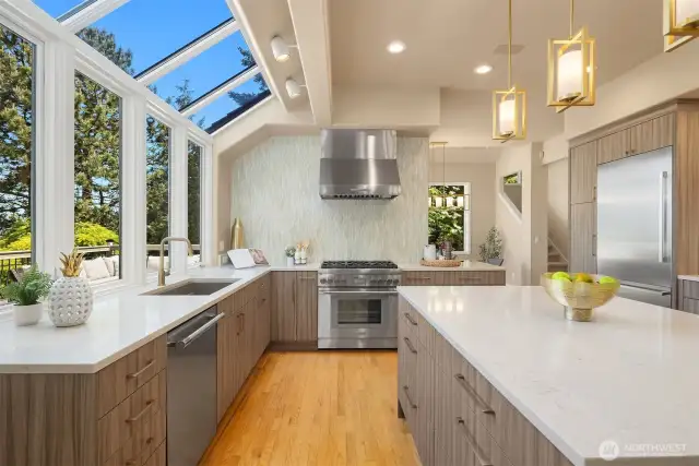 No expense was sparred with this kitchen remodel. Note the tiled wall behind the range, and full Thermador appliances throughout including 6-burner range, an additional oven and microwave (not shown) and large counter depth fridge/freezer.