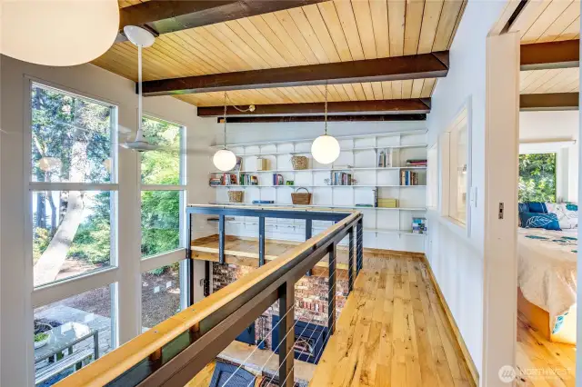 Upper loft area. Note the wall of shelves for display or library storage.
