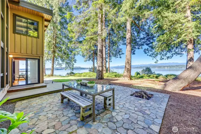 Just look at that beautiful stone patio with a fire pit and pretty views.