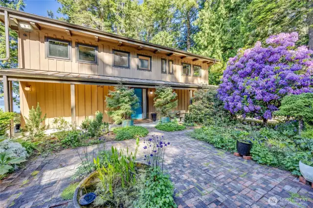 Courtyard entrance with pretty gardens surrounding.