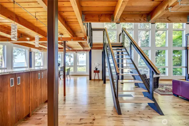Stunning open concept home with wall of windows, stunning staircase and granite topped built ins.