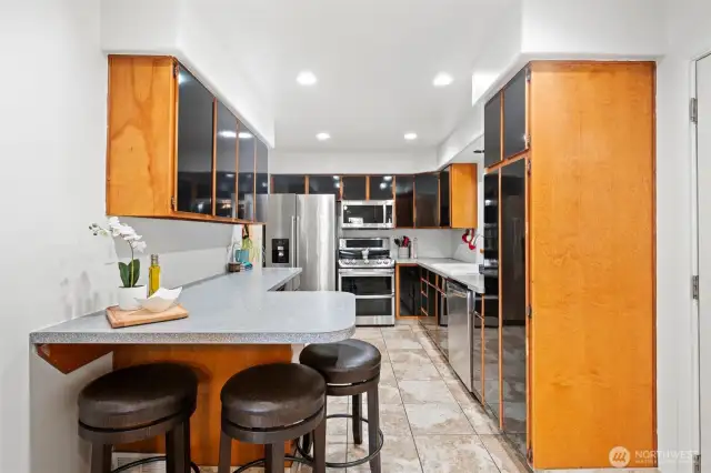 Kitchen with bar eating space, tile floors and lots of storage!