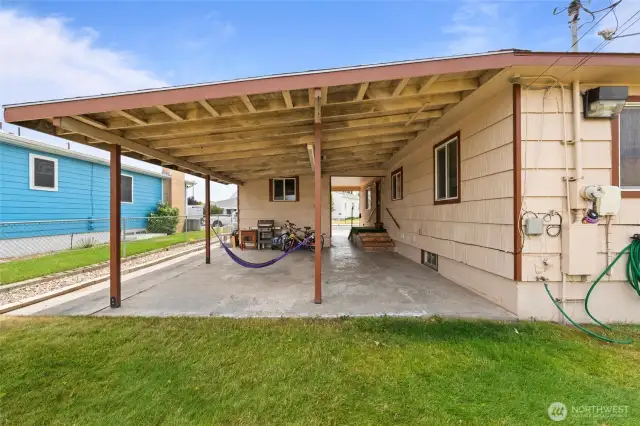 Covered back patio with lots of space for BBQ, patio furniture and storage.
