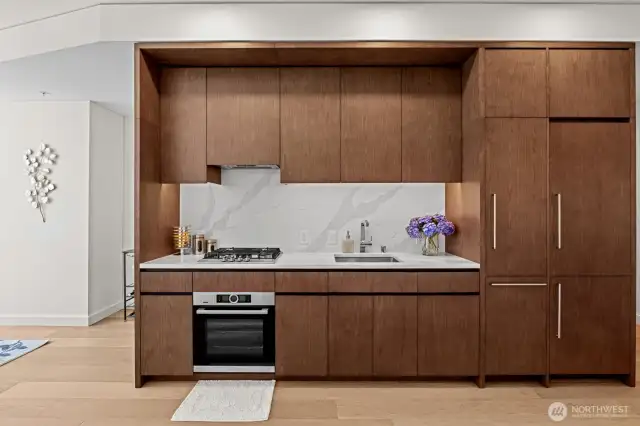 Custom wood cabinets with wood paneled fridge, freezer and dishwasher.