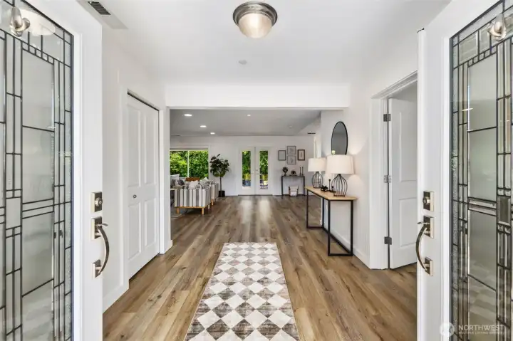 French front doors lead to extra wide entry.