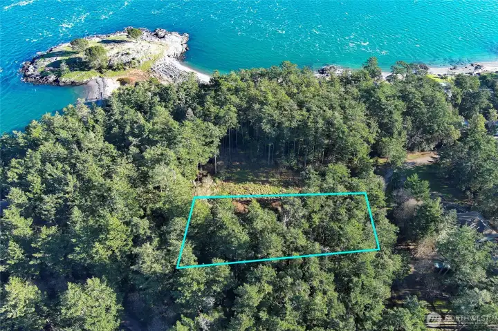 Aerial overview capturing the lot’s location near the shoreline and within the Cape San Juan community, known for marina access, community waterfront, and nearby parklands.