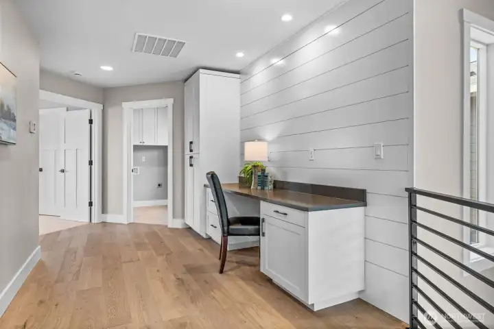 Custom built ins provide desk area & pantry style cabinetry for generous storage.