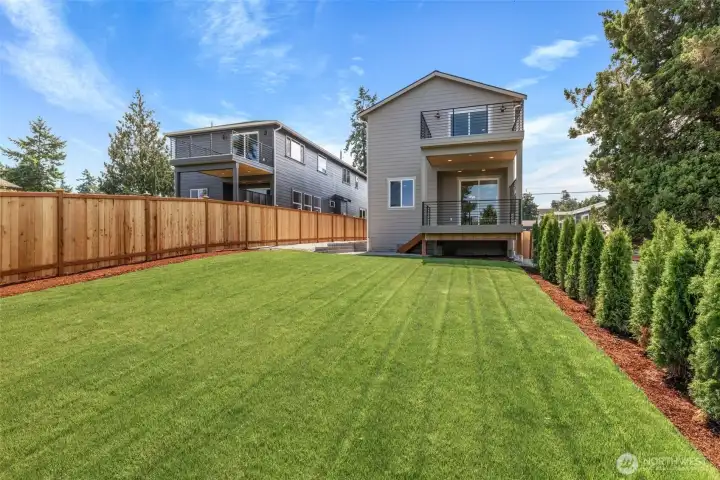 Deep yards with graveled walkway to one of 2 gates on this home.