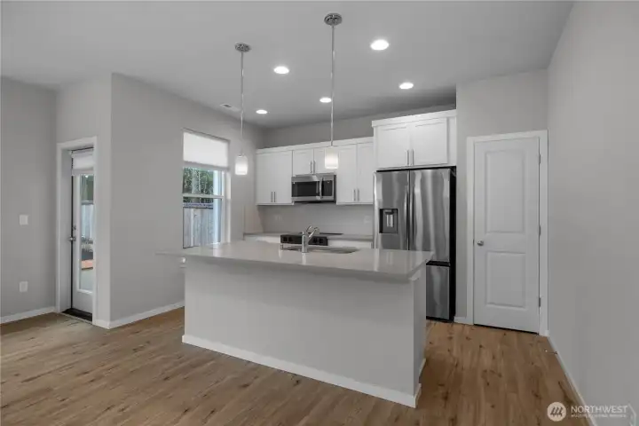 Large island with sink and seating, offering both functionality and a central gathering space.