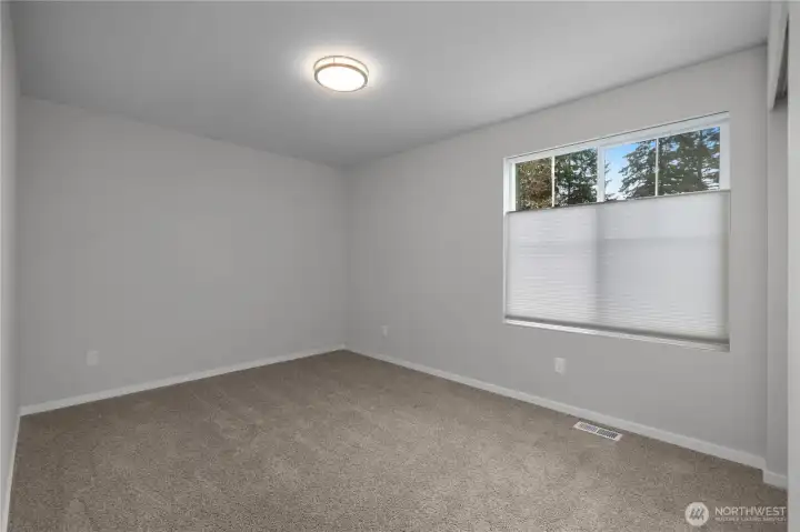 BR 2 - Spacious bedrooms with large window and neutral finishes.