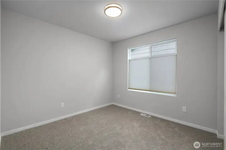 BR 4 - Comfortable guest room with ample wall space and modern trim.