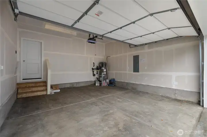 Clean garage space with room for vehicles and gear.