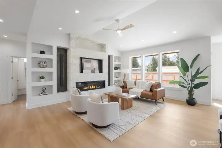 Large windows, vaulted ceilings. Large electric fireplace, stone to the ceiling to match exterior, built in shelving and lighting.