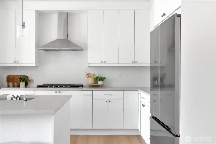 Beautiful upgraded gray-stone quartz counters. Herringbone tile backsplash. Soft-close cabinets.