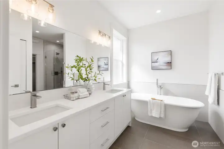 Large double sink vanity. Quartz counters, tile backsplash. Tub surround tile.
