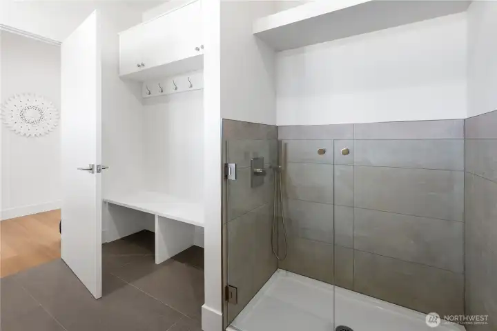 The mudroom also has built-in quartz bench, hangers, and cabinets for coats, shoes. Large tile washing/hose-off station for kids, dirty shoes, cleaning pets, washing off outdoor gear.