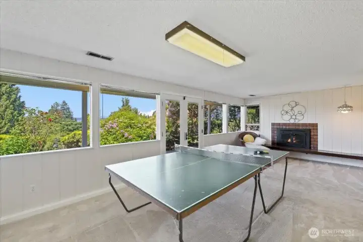 rec room on lower level with a fireplace and access to the yard