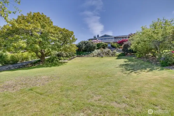 Expansive yard below for playing, gardening and etra privacy