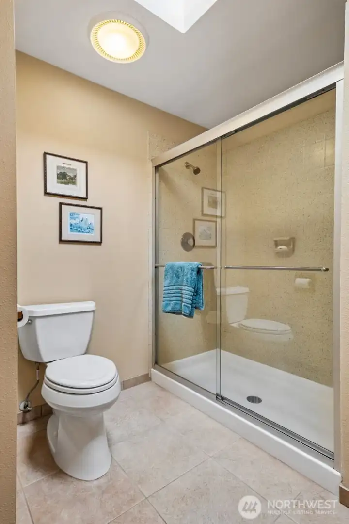 The other half of the primary bedroom features this HUGE walk-in shower and toilet area. The other half of the primary bedroom features this HUGE walk-in shower and toilet area.