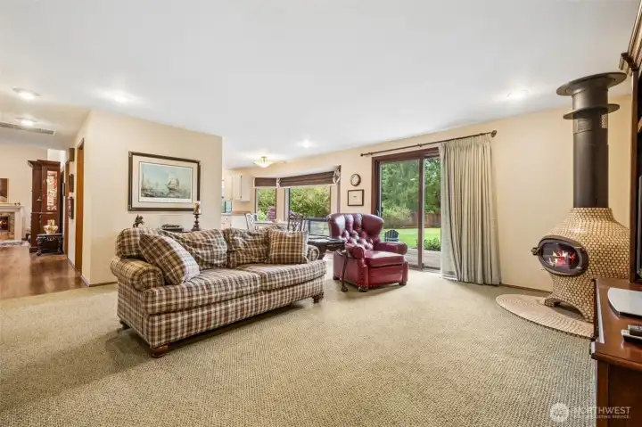 Just off the kitchen is this family room with a wood burning Meridian onion stove with tile hearth. One of a kind and fun for those darker NW evenings. Just off the kitchen is this family room with a wood burning Meridian onion stove with tile hearth. One of a kind and fun for those darker NW evenings.