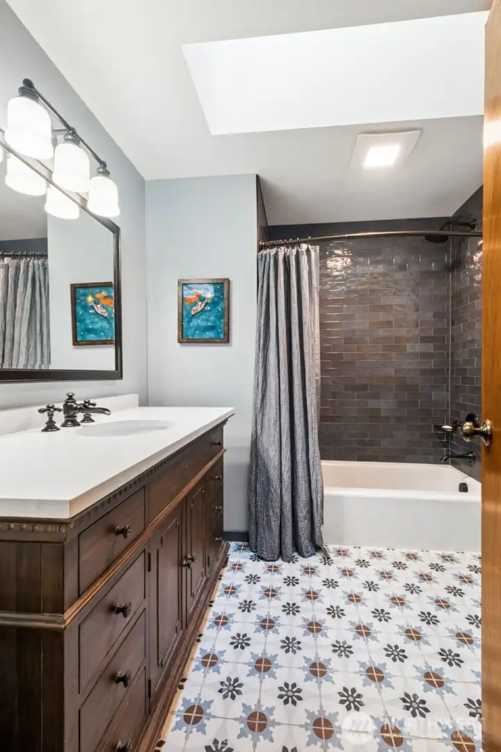 Near both living areas is the guest bath, remodeled with Restoration Hardware Vanity, designer tile flooring, and marvelous tile work done for the tub surround. Near both living areas is the guest bath, remodeled with Restoration Hardware Vanity, designer tile flooring, and marvelous tile work done for the tub surround.