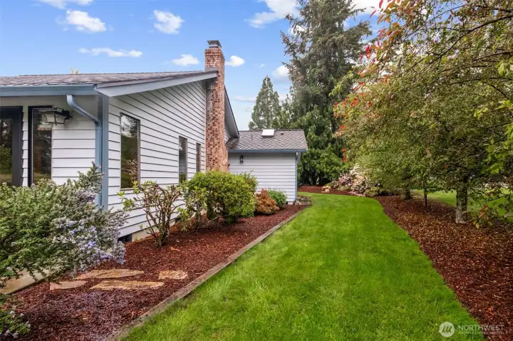 A view of the spacious side yard with mature trees for privacy. A view of the spacious side yard with mature trees for privacy.