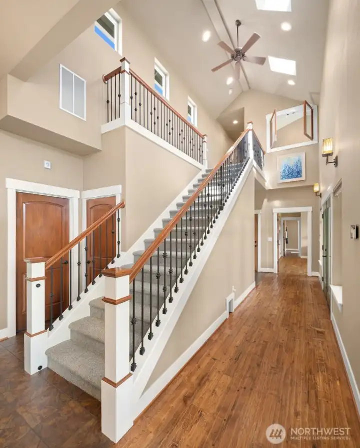 Towering staircase with elegant balusters. Let's take a look upstairs.