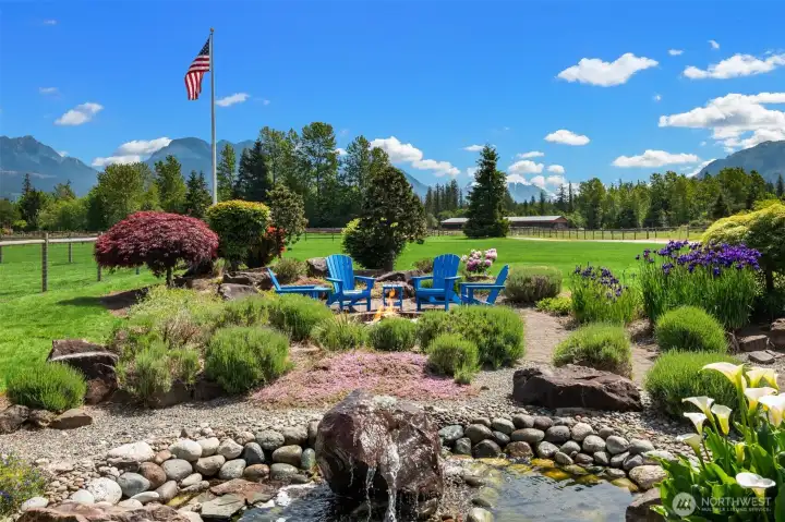 Serene back patio space with meticulous landscaping. Your own private oasis.