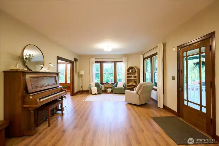Formal living room North end with original well maintained pocket doors. This space is great for large gatherings. Formal living room North end with original well maintained pocket doors. This space is great for large gatherings.