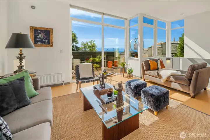 The home is wide and spacious, with indoor-outdoor flow and water views from every floor.