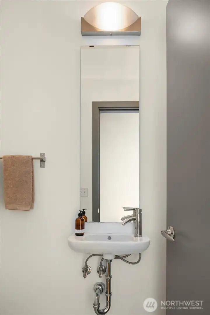 A cleverly concealed powder room serves the main floor.