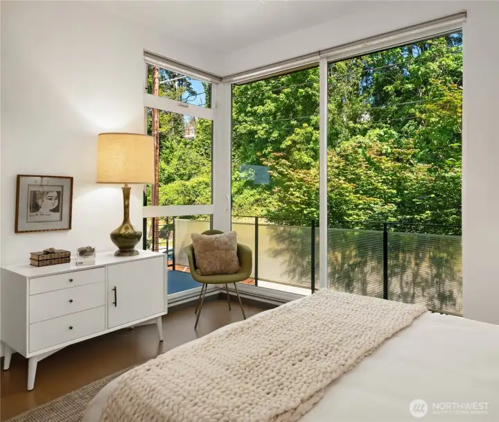 A private balcony and lush green views from the secondary bedroom.