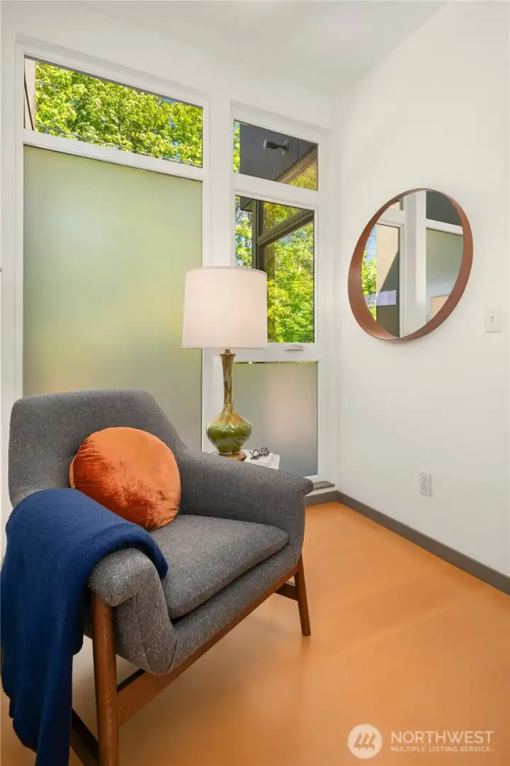 The 2nd of 3 non-bedroom flex spaces has great morning light and leafy views toward the green belt across the street.